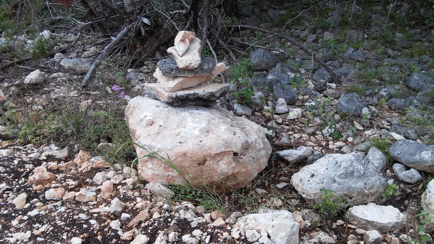 A rock figure appears as standing proud and ready to lecture