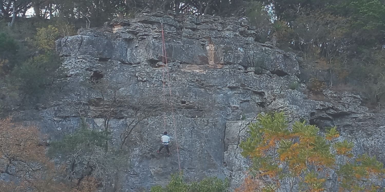 A rock climber scales the rocks at Medicine Wall