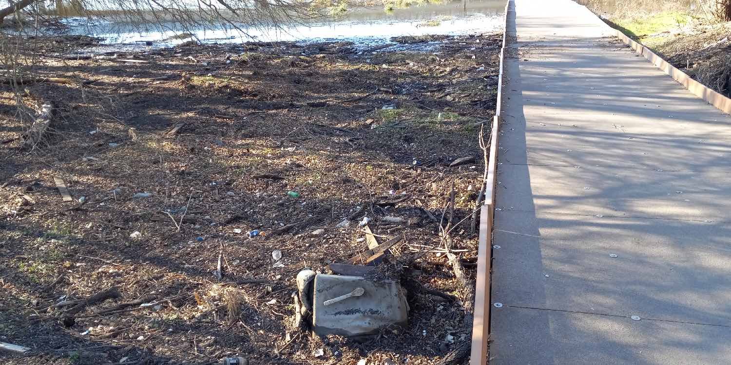 With a tossed recliner, trash collects next to the Morningstar Boardwalk on the Salado Creek Greenway—Photo: SRR